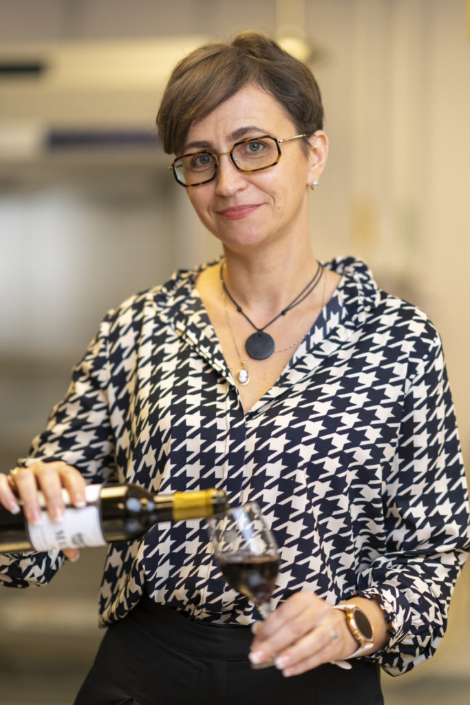 Pouring a glass of wine is Andreea Botezatu, Ph.D.