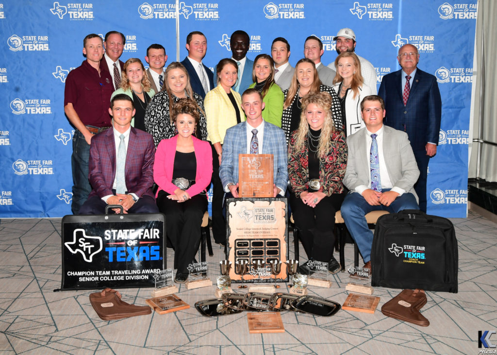 Members of the 2022 Livestock Judging Team pose with coaches, mentors and trophies won at the State Fair of Texas contest.