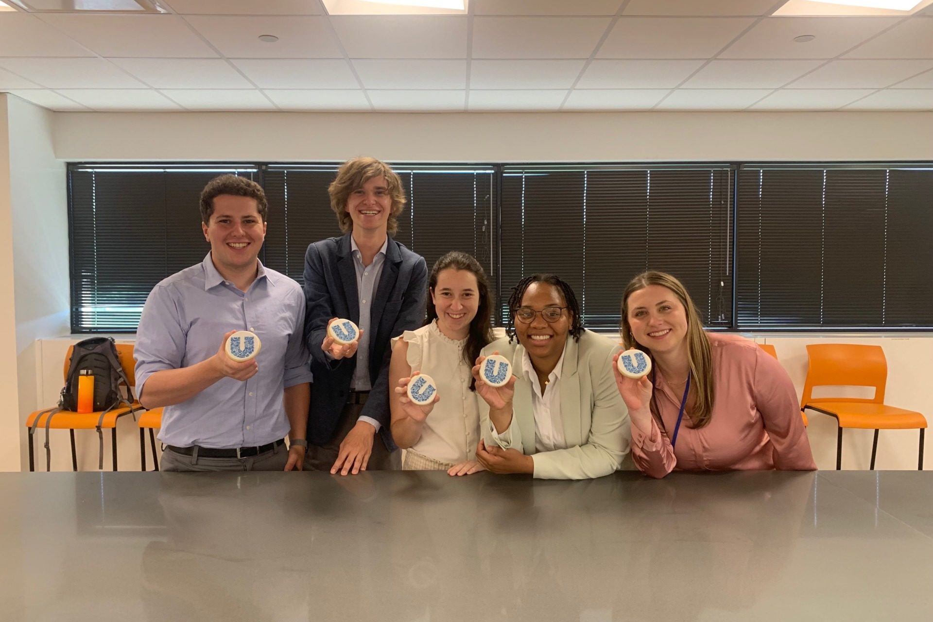 Five Unilever interns, including Allison Brenner, pose with cookies that have the Unilever logo.