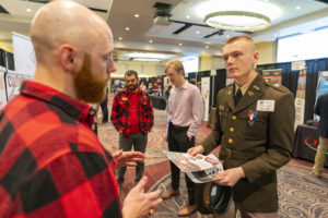 A member of the Texas A&M Corps of Cadets visits with a recruiter at the AGLS Career Fair.