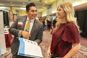 A recruiter visits with a current student about his company at the AGLS Career Fair.