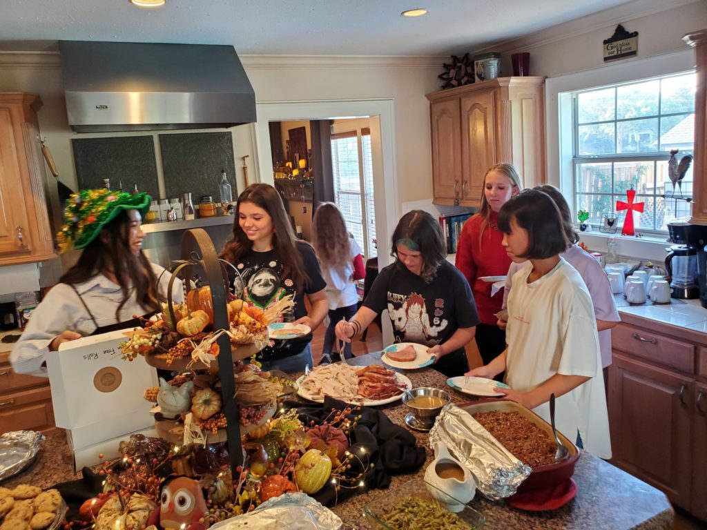 Japanese delegates and host familes in Wise County sharing a Thanksgiving experience during the summer exchange homestay 