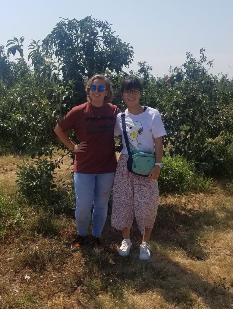 Katelyn Besler, left, and Japanese delegate Iori Kimagai at the Top of Texas apple orchard in Idalou