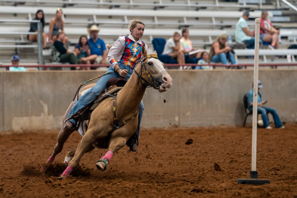 Female rider demonstrating precision riding skills at Texas State 4-H Horse Show.