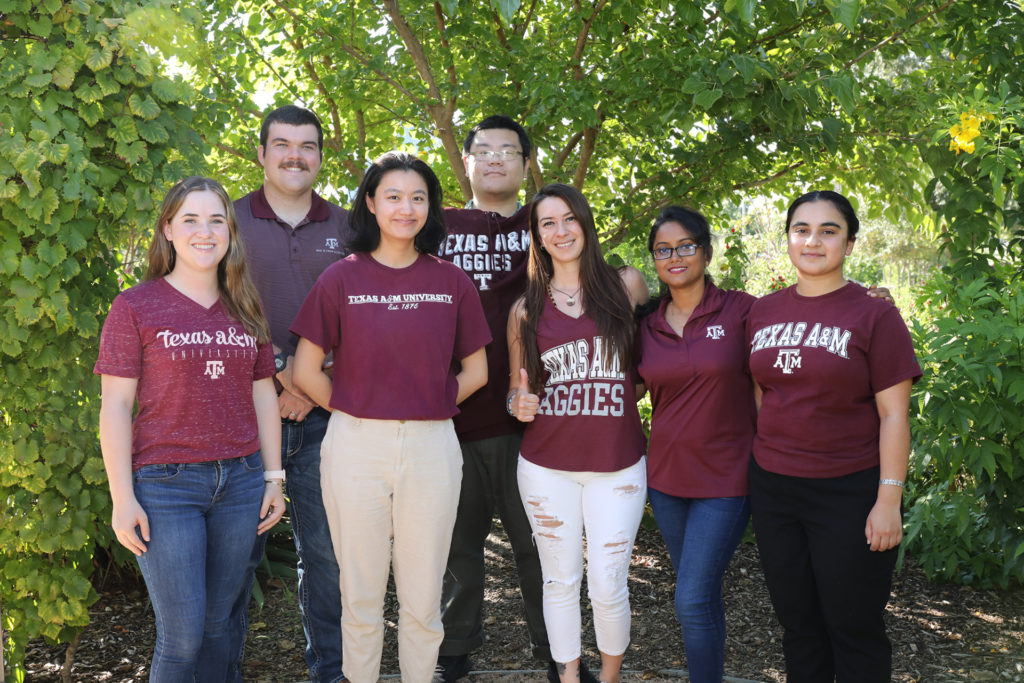 A team picture of seven students who led the plant breeding symposium are dressed in their maroon shirts