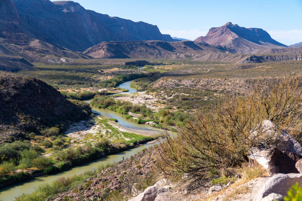 A river flows in an arid mountain landscape of West Texas.