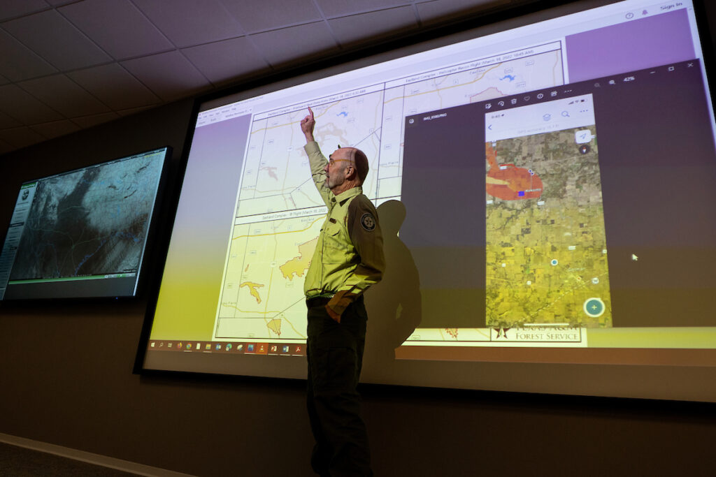 Predictive Services Department Head Brad Smith points at a screen inside of the Texas A&M Forest Service Emergency Operations Center (EOC) at the agency headquarters in College Station. 