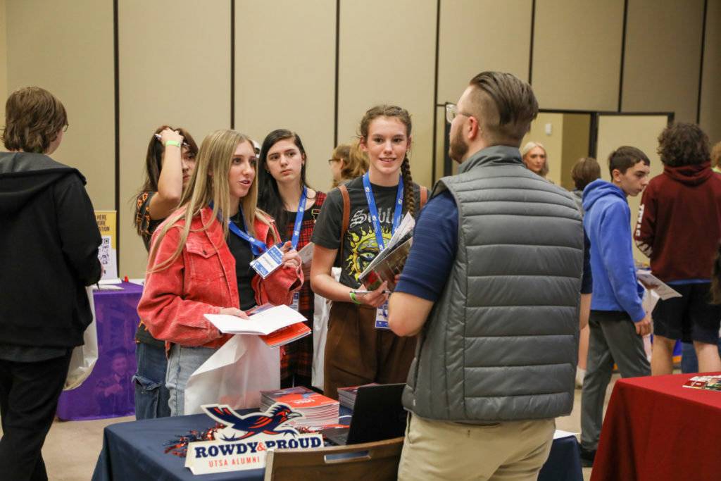 Student participants speaking with a university representative at the RSSI College and Career Expo. 