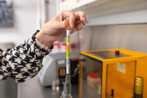 A hydrometer being used in a wine lab.