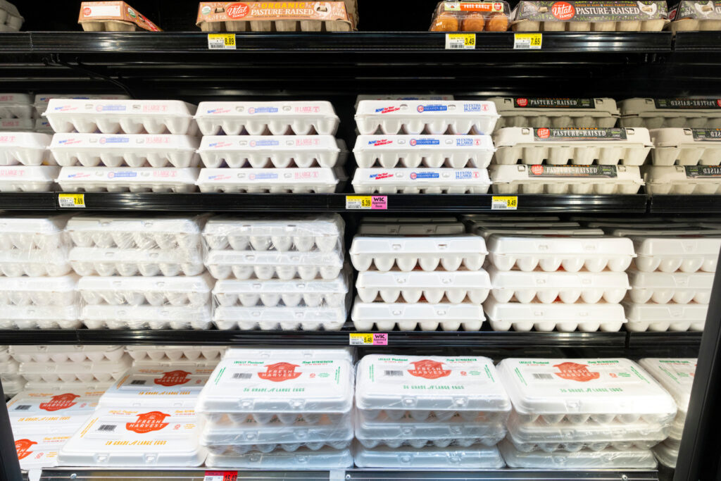 egg cartons stacked in a grocery store setting