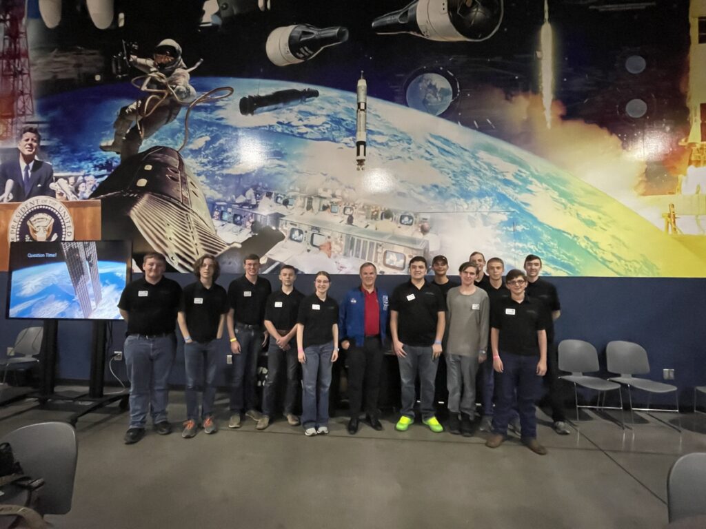Group photo of 4-H ambassadors with NASA space backdrop