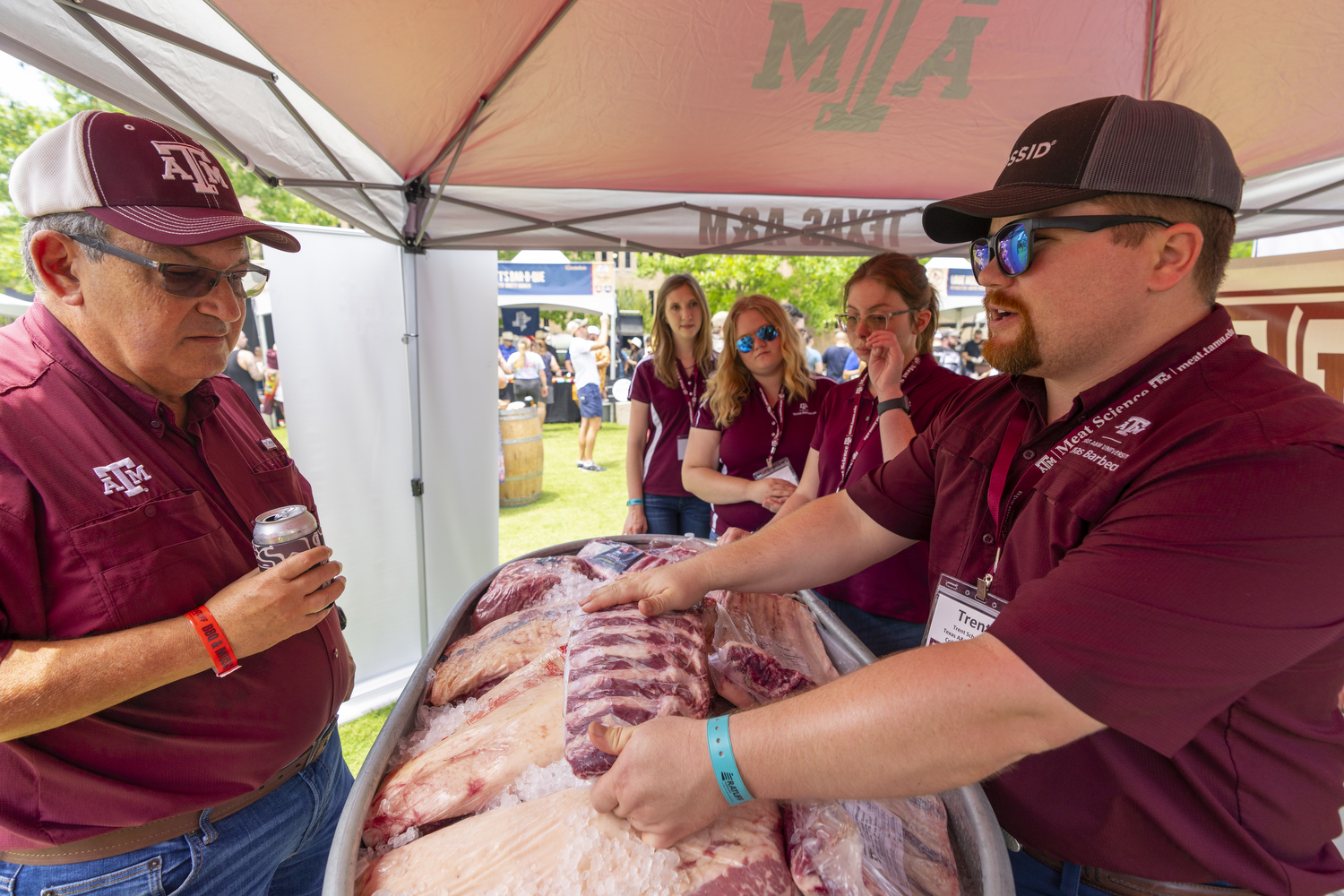 A Texas A&M student shows ribs to a guest during the Troubadour Festival