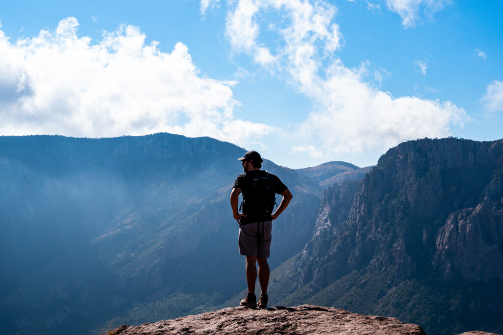 A man standing on a mountain peak
