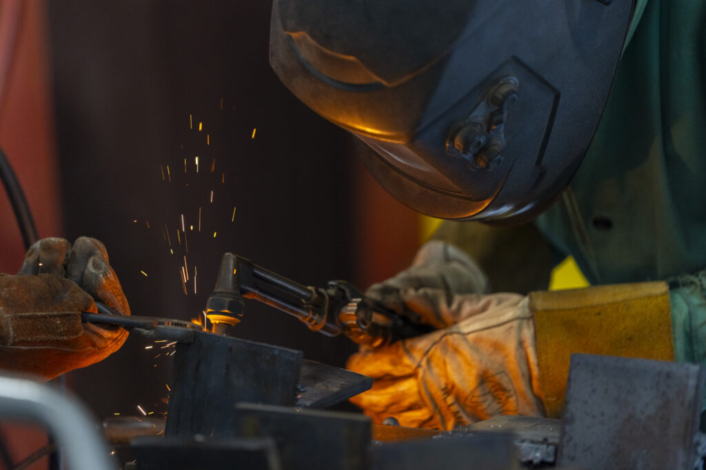 A welder using a blowtorch.