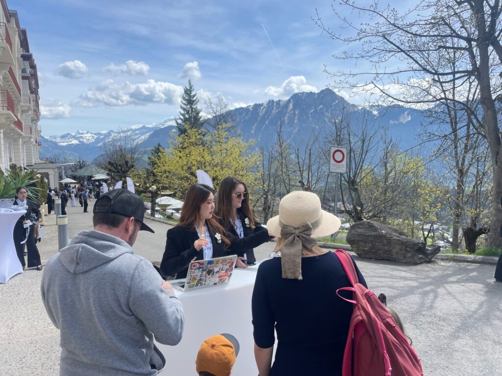 Two students greet two guests the World of Hospitality event in Leysin 