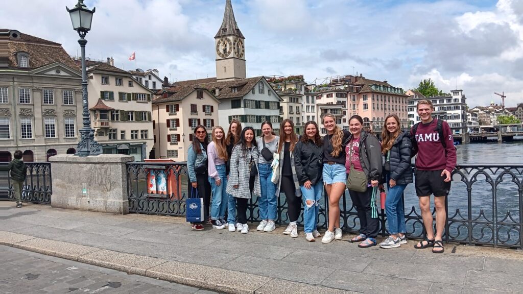 A group of Texas A&M students gathers on a bridge in Zurich