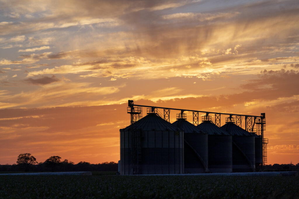A set of grain bins at sunset in Texas.