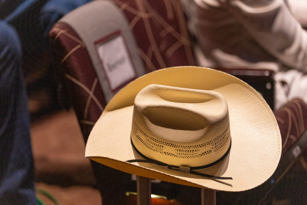 A cowboy hat rests on a chair in Rudder Auditorium during the Beef Cattle Short Course