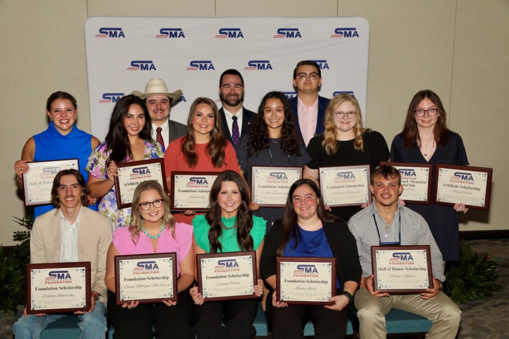 14 students pose together during a scholarships award ceremony by the Southwest Meat Association Foundation.
