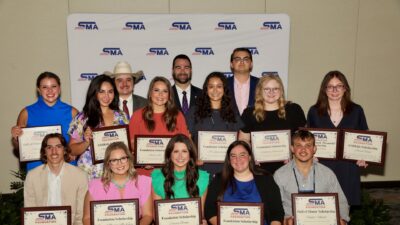14 students pose together during a scholarship presentation by the Southwest Meat Association Foundation.