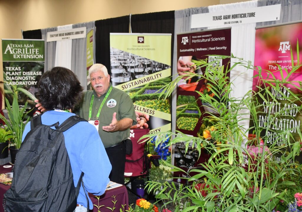 A man speaks to an attendee at a booth during the TNLA expo where information and advice was provided to green industry stakeholders 