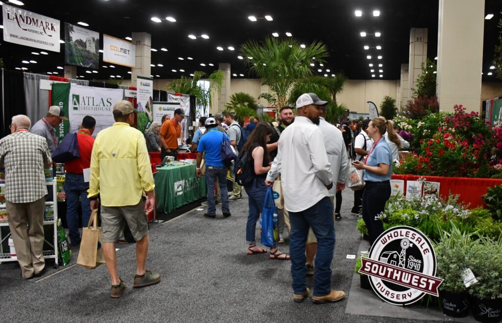 Attendees walk among green industry booths at the 2023 Texas Nursery and Landscaping Association expo