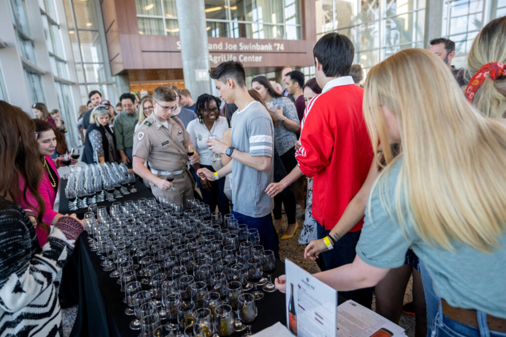 Texas A&M students gather around wine glasses at a Spirited Learning event. 