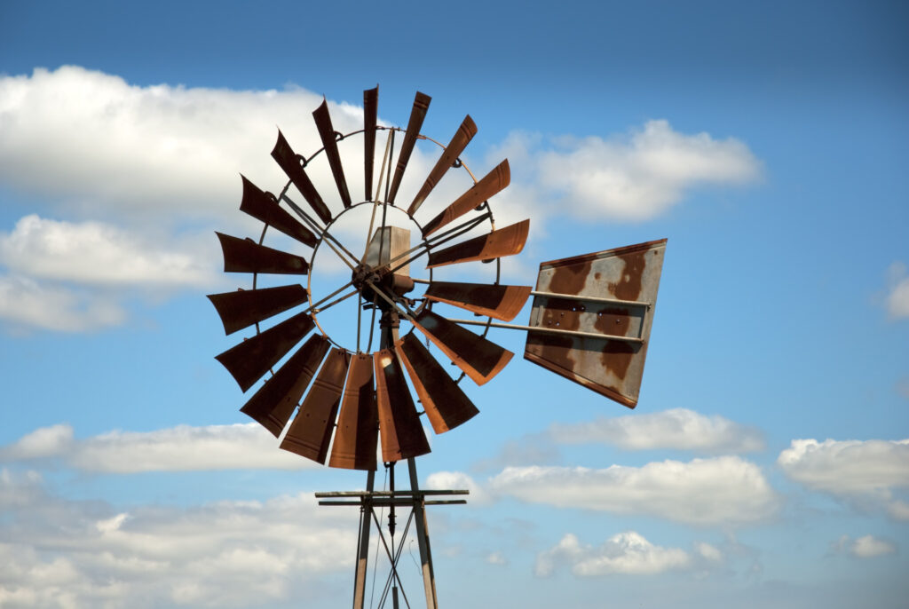 Rusty windmill with clouds in the background. Residents in the Rolling Hills region in Texas can have their well water screened during six Texas Well Owner Network events.