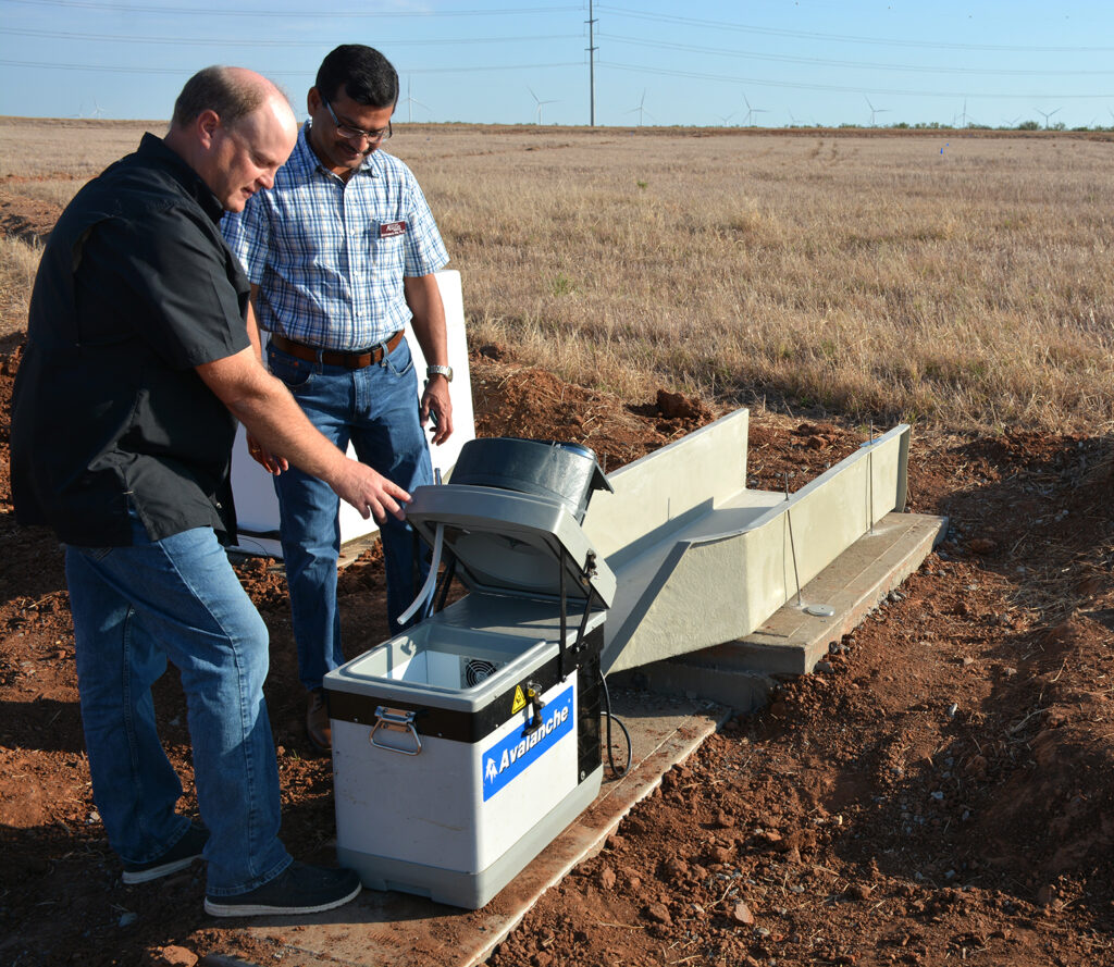 Texas A&M AgriLife researchers Paul DeLaune and Srini Ale look at an edge-of-field automatic water sampler. Soil health management will be one of the topics at the Sept. 27 Regenerative Agriculture Field Day.