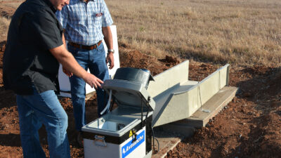 Texas A&M AgriLife researchers Paul DeLaune and Srini Ale look at an edge-of-field automatic water sampler.