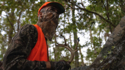 A hunter rattles antlers to attract deer.