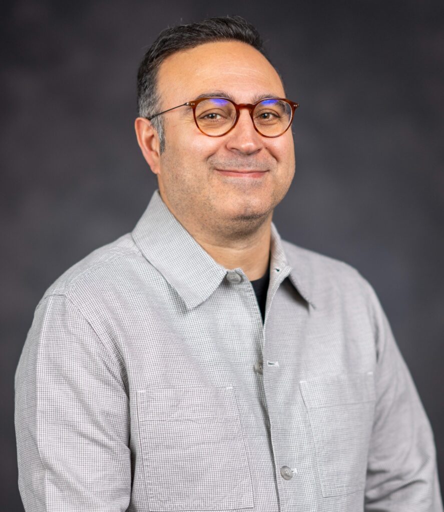 Head and shoulder photo of Babek Taheri, Ph.D. He is wearing a gray shirt and has on glasses.