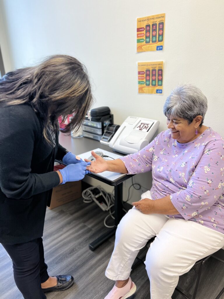 Healthy South Texas participant Lupe Ovalle getting blood glucose level checked