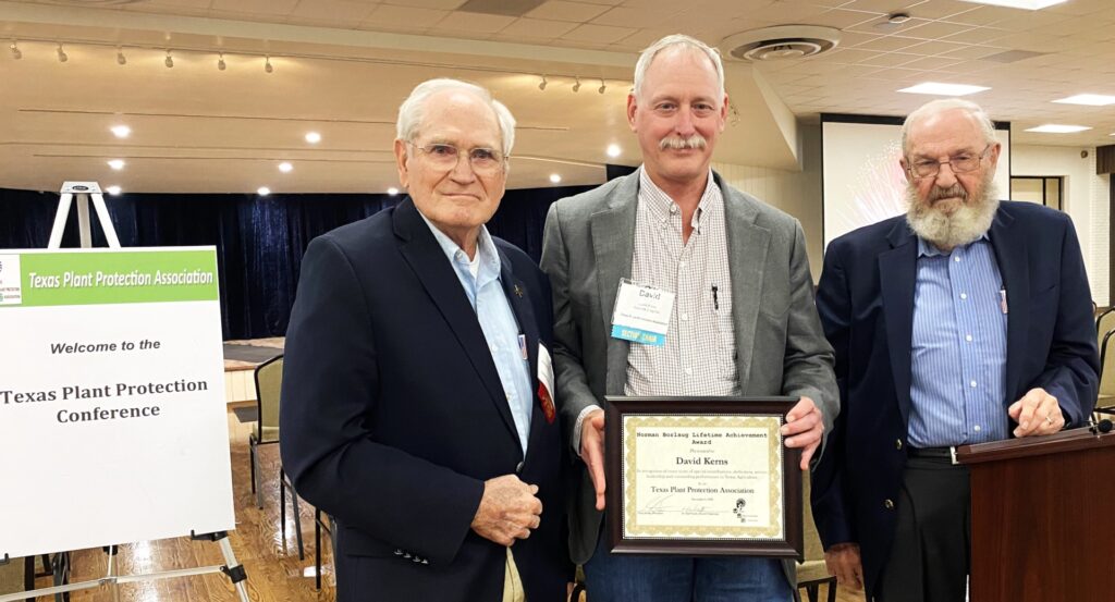 David Kerns holds the plaque for his award between two members of the Texas Plant Protection Association. 