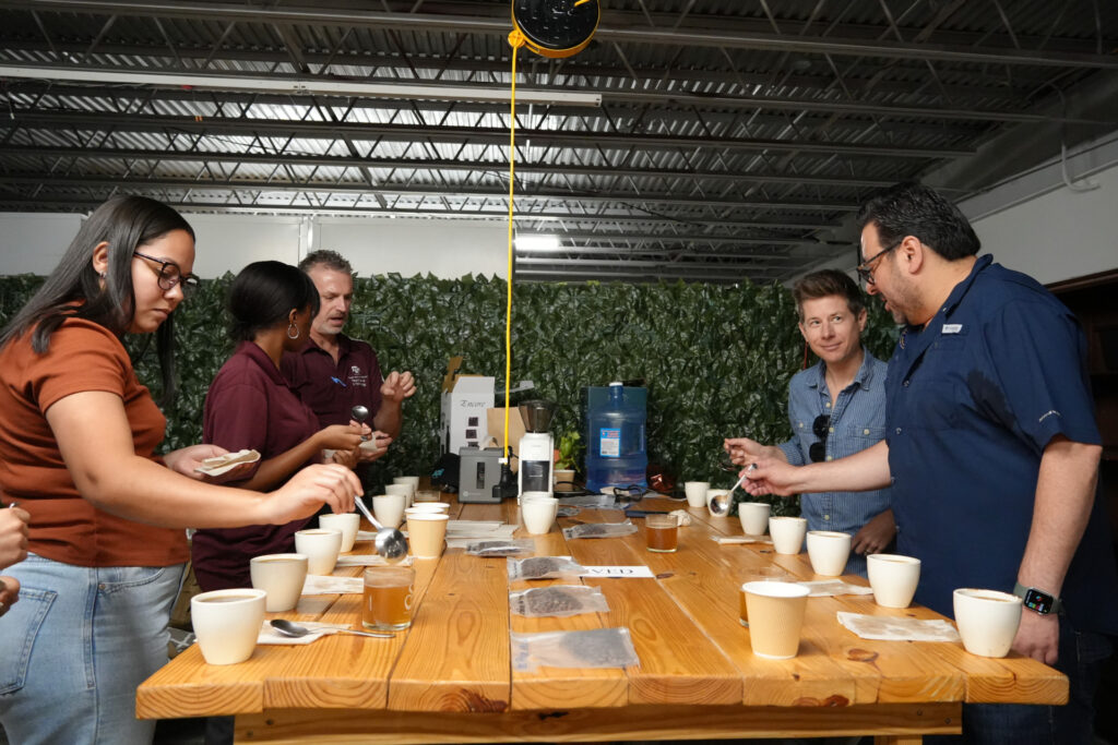 Group of people tasting a number of different coffees
