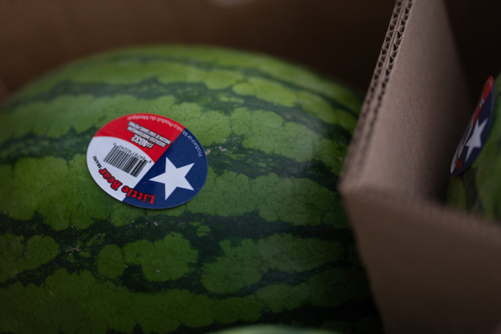 A watermelon with a Texas-flag barcode sticker on it. 