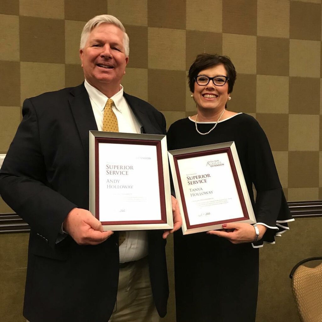 Andy and Tanya Holloway posing for a picture while holding their 2017 Texas A&M AgriLife Extension Service Superior Service Awards. 