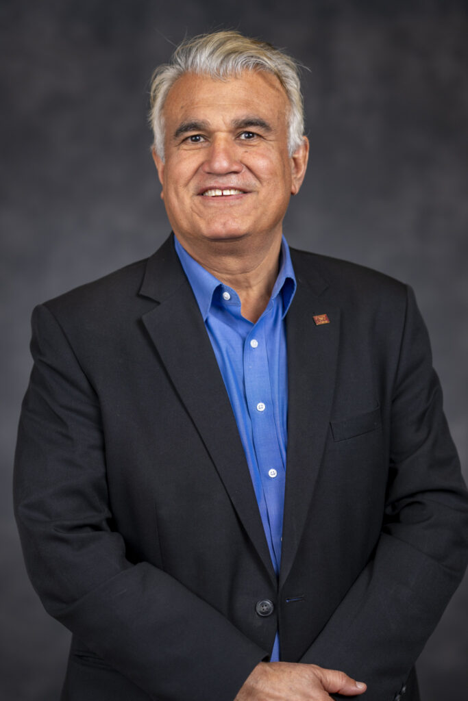 Headshot of a man, Mian Riaz, Ph.D. He is wearing a blue shirt and navy blue blazer. Riaz is a associate head of the Department of Food Science and Technology
