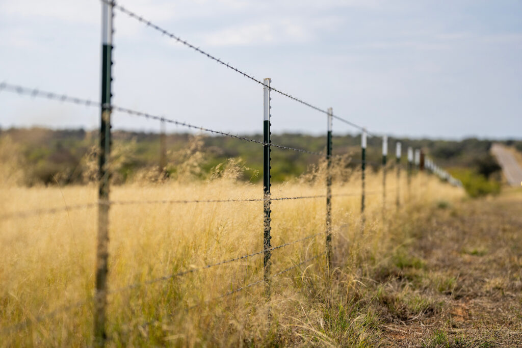 A fence lining the road in West Texas. Fence laws will be one of several topics discussed during the April 23 Owning Your Piece of Texas workshop in San Angelo.