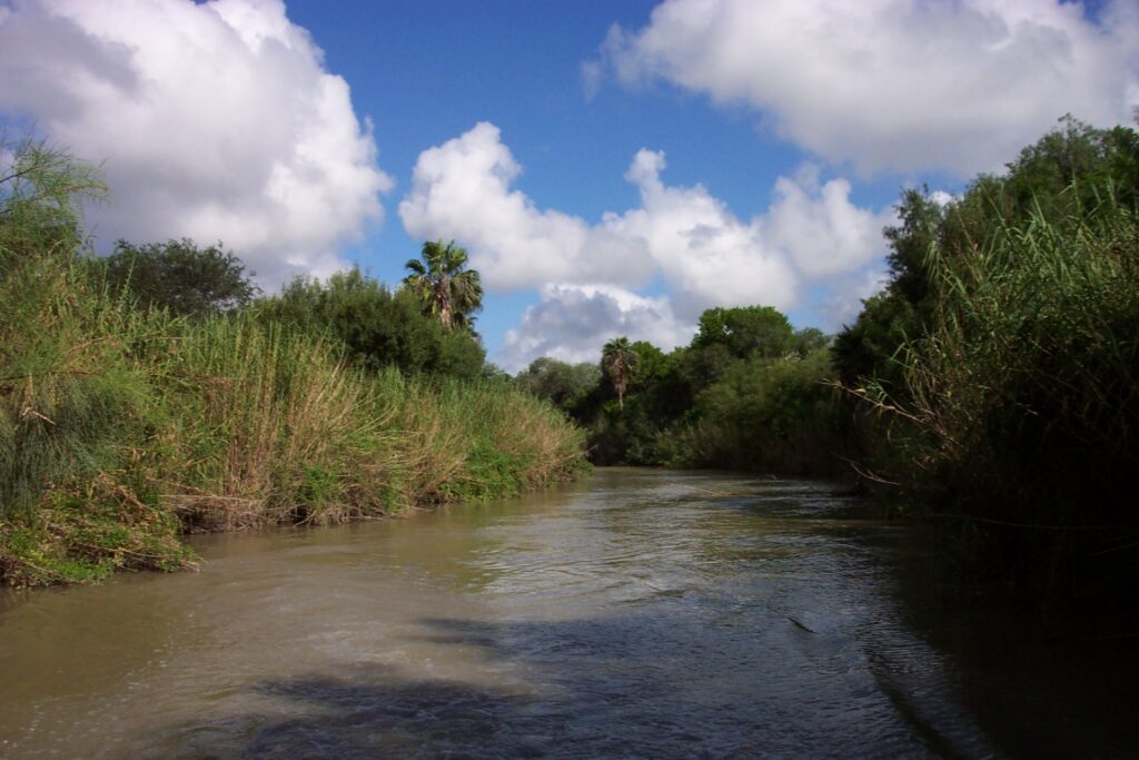 The Arroyo Colorado with trees and grass lining its banks. The watershed will be discussed during the Texas Riparian and Stream Ecosystem Education Program workshop in Kingsville on April 30