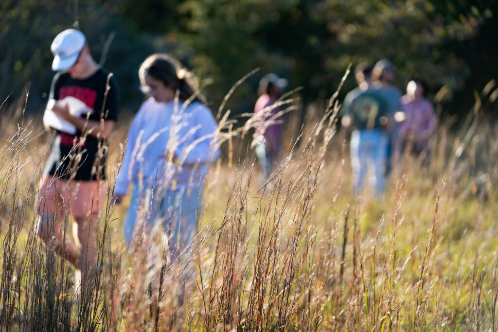 Students walking through a field. 