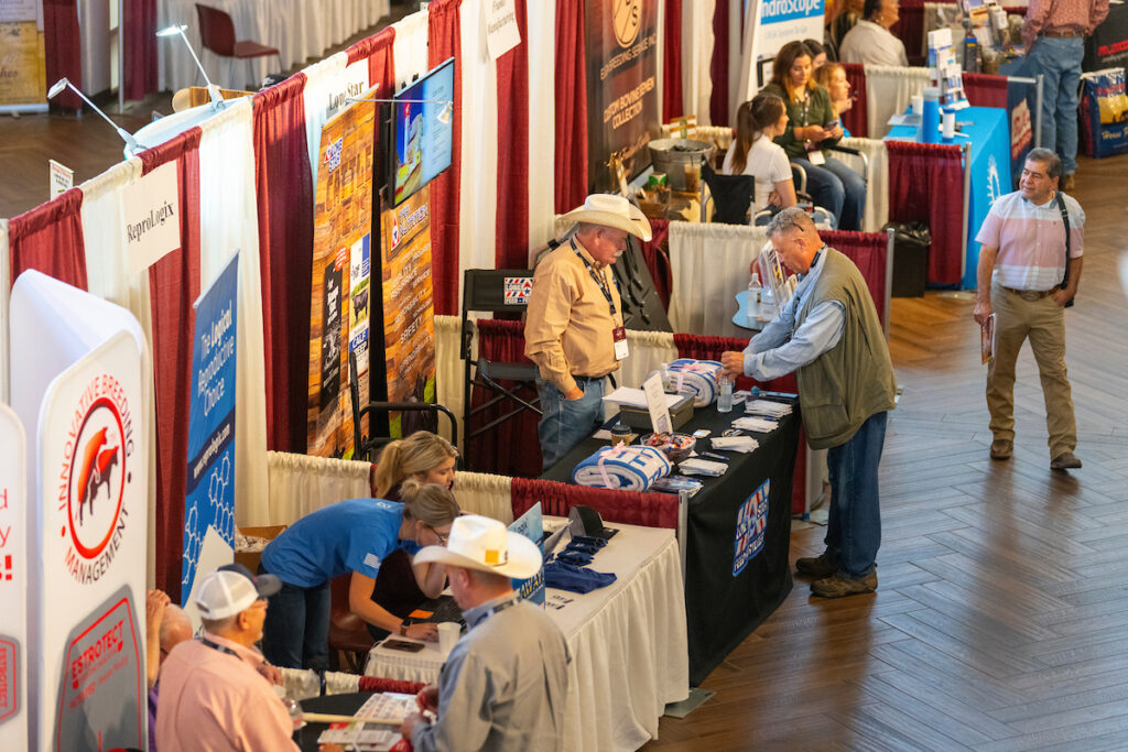 A large open space that has many trade show exhibit booths set up at the Texas A&M Beef Cattle Short Course