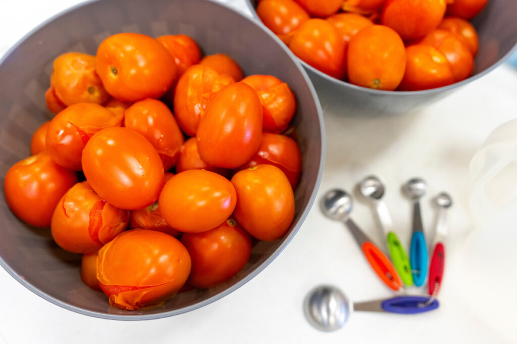 Two bowls of tomatoes on a table. Participants will learn how to prepare food during a home canning workshop held on May 18 in Waco. 