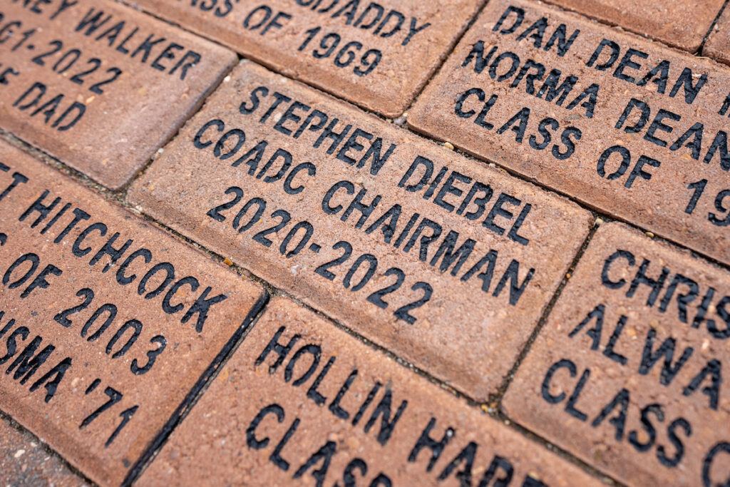 A closeup of commemorative engraved bricks on the Path to The Gardens.