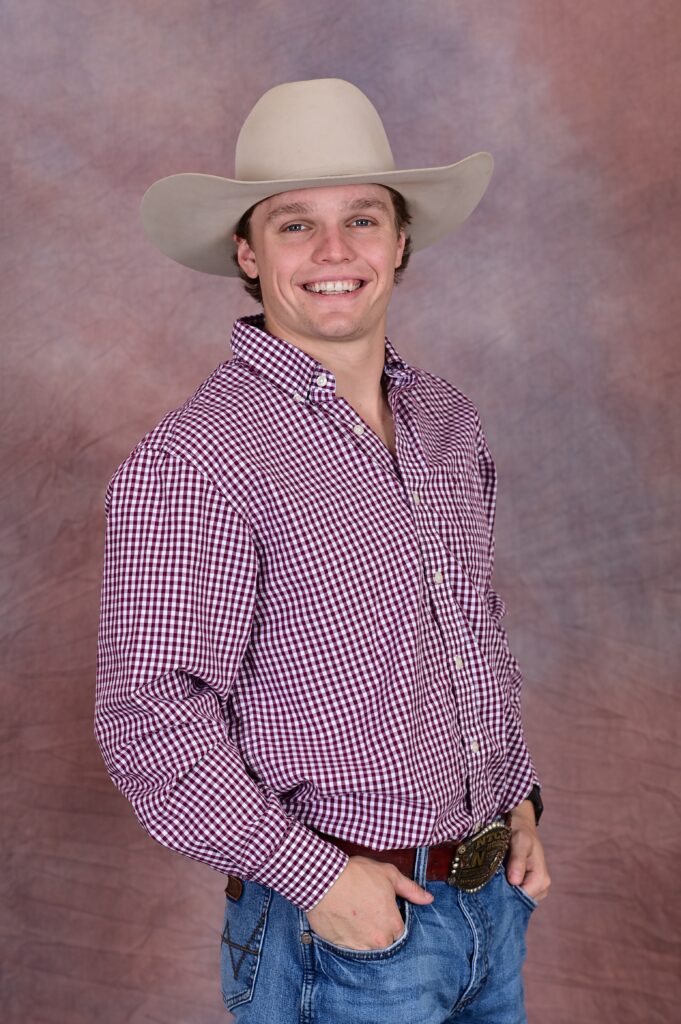 smiling male student in a tan cowboy hat