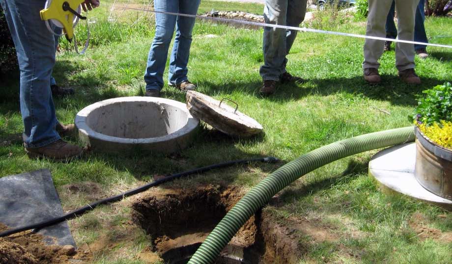 A septic system is open for maintenance at a home.