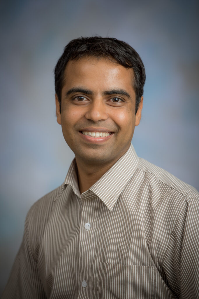 A smiling man, Sushil Paudyil, assistant professor in the Department of Animal Science