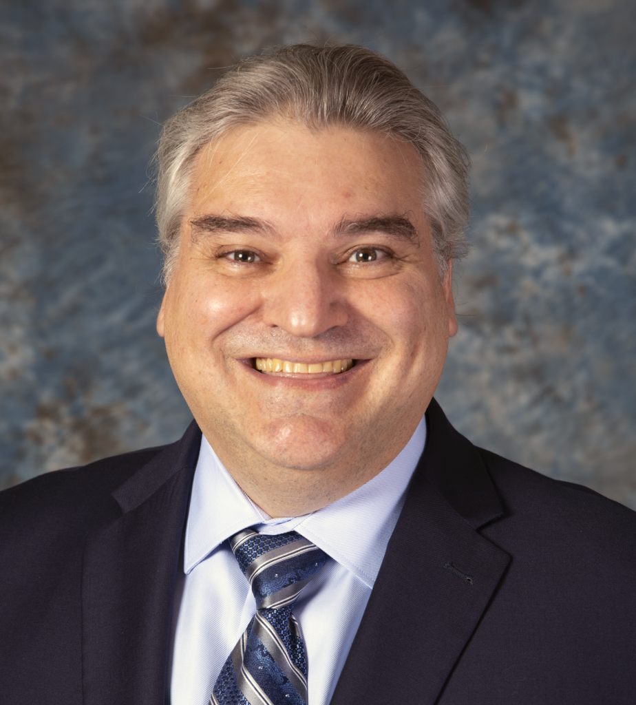 A smiling man in a suit and tie, Luis Tedeschi, Ph.D., Texas A&M AgriLife Research Faculty Fellow, Chancellor EDGES Fellow, animal nutritionist and professor